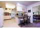 Bright kitchen with a breakfast bar and a view of an adjacent living space at 10106 W Highwood Ln, Sun City, AZ 85373