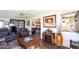 Comfortable living room with a decorative fireplace and adjacent kitchen view at 10106 W Highwood Ln, Sun City, AZ 85373