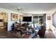 Cozy living room with a ceiling fan and a sliding glass door to the backyard at 10106 W Highwood Ln, Sun City, AZ 85373