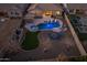 Spectacular aerial view of backyard featuring a sparkling pool, spa, inviting seating, and lush landscaping at 10547 E Relativity Ave, Mesa, AZ 85212