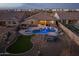 Stunning aerial view of backyard featuring a pool, spa, outdoor kitchen, and inviting seating area, perfect for entertainment at 10547 E Relativity Ave, Mesa, AZ 85212