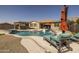 A backyard pool and tanning chairs create a private oasis for relaxation and outdoor entertaining at 10547 E Relativity Ave, Mesa, AZ 85212