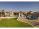 Backyard oasis featuring a sparkling pool, inviting seating areas, and lush landscaping for ultimate relaxation at 10547 E Relativity Ave, Mesa, AZ 85212