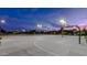 Well-lit community basketball court under a twilight sky, providing a perfect space for recreation at 10547 E Relativity Ave, Mesa, AZ 85212