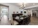 Formal dining room featuring a dark wood table, seating for eight, and a decorative chandelier at 10547 E Relativity Ave, Mesa, AZ 85212