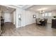 View of the dining room connected to the entryway, featuring a chandelier and large dining table at 10547 E Relativity Ave, Mesa, AZ 85212