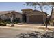 Beautiful home with a stone front, well-kept yard, and a driveway leading to a two-car garage at 10547 E Relativity Ave, Mesa, AZ 85212