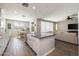 Modern kitchen with a center island, breakfast nook, and seamless flow to the living area at 10547 E Relativity Ave, Mesa, AZ 85212