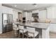 Modern kitchen featuring a large island, white cabinetry, granite countertops, and stainless steel appliances at 10547 E Relativity Ave, Mesa, AZ 85212