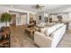 Open concept living room featuring wood-style flooring, neutral tones, and a large comfortable sofa at 10547 E Relativity Ave, Mesa, AZ 85212