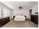 Spacious main bedroom featuring a large bed, ceiling fan, and neutral color scheme at 10547 E Relativity Ave, Mesa, AZ 85212