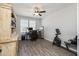 Home office featuring hardwood floors, a ceiling fan, built in shelves, and a work station by the window at 10547 E Relativity Ave, Mesa, AZ 85212