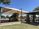 Community playground features a covered play structure with slides and picnic tables for Gathering fun at 1077 E Loma Vista St, Gilbert, AZ 85295