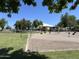 Community sand volleyball court with green lawns is perfect for neighborhood recreational activities at 1077 E Loma Vista St, Gilbert, AZ 85295