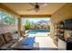 Inviting backyard patio with comfortable seating overlooking the sparkling pool at 10817 W Swayback Pass, Peoria, AZ 85383