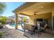 Comfortable backyard patio and seating area offer views of the pristine pool at 10817 W Swayback Pass, Peoria, AZ 85383