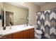 Bright bathroom features double sinks, and stylish shower curtain at 10817 W Swayback Pass, Peoria, AZ 85383