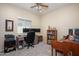 Bedroom featuring a ceiling fan, a desk with computer monitors, and a bookshelf at 10817 W Swayback Pass, Peoria, AZ 85383