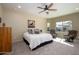 Cozy bedroom featuring neutral tones, comfortable seating, and a ceiling fan for enhanced comfort at 10817 W Swayback Pass, Peoria, AZ 85383