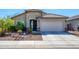 Charming single-story home featuring a well-manicured front yard and an attached two-car garage at 10817 W Swayback Pass, Peoria, AZ 85383