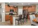 Beautiful kitchen with granite countertops, stainless steel appliances and a convenient island with barstool seating at 10817 W Swayback Pass, Peoria, AZ 85383