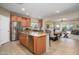 Open-concept kitchen featuring granite countertops, stainless steel appliances, and a center island with seating at 10817 W Swayback Pass, Peoria, AZ 85383