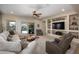 Comfortable living room boasts a built-in media center with shelving and a ceiling fan for added comfort at 10817 W Swayback Pass, Peoria, AZ 85383