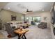 Spacious living room features neutral color palette, plush carpeting, and sliding door access to outdoor pool area at 10817 W Swayback Pass, Peoria, AZ 85383