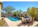 Inviting backyard pool with a dining set for outdoor relaxation and entertaining in a private, landscaped setting at 10817 W Swayback Pass, Peoria, AZ 85383