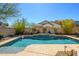 Sparkling swimming pool with a Baja shelf and lush landscaping at 10817 W Swayback Pass, Peoria, AZ 85383