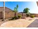 Landscaped backyard featuring mature trees, shrubbery, a stone fire pit, and decorative stone walkways at 11029 W Oraibi Dr, Peoria, AZ 85373