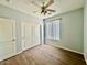 Bedroom with a ceiling fan, window, and closet with sliding doors at 11029 W Oraibi Dr, Peoria, AZ 85373