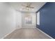 Bright bedroom with neutral walls, wood-look floors, and a window for natural light at 11029 W Oraibi Dr, Peoria, AZ 85373