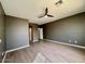 Bright bedroom with a ceiling fan and wood-look flooring at 11029 W Oraibi Dr, Peoria, AZ 85373