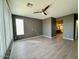 Spacious bedroom featuring a ceiling fan, window, and wood-look flooring at 11029 W Oraibi Dr, Peoria, AZ 85373