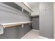 Walk-in closet offers ample storage with built-in shelving and wood-look floors at 11029 W Oraibi Dr, Peoria, AZ 85373