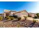 Inviting single-story home with desert landscaping, a two-car garage and a beautiful tile roof at 11029 W Oraibi Dr, Peoria, AZ 85373