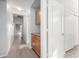 Hallway featuring wood cabinets and tile floors at 11029 W Oraibi Dr, Peoria, AZ 85373