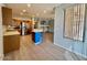 Kitchen featuring stainless steel appliances, wood cabinets, and kitchen island open to the living room at 11029 W Oraibi Dr, Peoria, AZ 85373