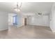 Open-concept living room with wood-look floors, a ceiling fan, an arched doorway, and modern lighting at 11029 W Oraibi Dr, Peoria, AZ 85373