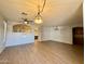 Spacious living room featuring wood look tile flooring, modern lighting, and open layout at 11029 W Oraibi Dr, Peoria, AZ 85373