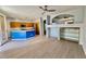 Living room open to kitchen, featuring wood look tile flooring, modern lighting, and an open layout at 11029 W Oraibi Dr, Peoria, AZ 85373