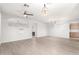 Open-concept living room with wood-look floors, a ceiling fan, arched doorway, and modern lighting fixtures at 11029 W Oraibi Dr, Peoria, AZ 85373