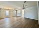 Spacious living room featuring wood look tile flooring, modern lighting, and open layout at 11029 W Oraibi Dr, Peoria, AZ 85373