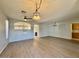 Spacious living room featuring wood look tile flooring, modern lighting, and open layout at 11029 W Oraibi Dr, Peoria, AZ 85373