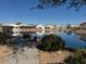 Idyllic pond view surrounded by lush landscaping and neighborhood homes at 11029 W Oraibi Dr, Peoria, AZ 85373