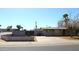 Single-story home featuring a low-maintenance desert landscape and long driveway at 1209 W 1St Pl, Mesa, AZ 85201