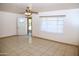 Neutral living area featuring tile flooring, a ceiling fan, and a large window at 1209 W 1St Pl, Mesa, AZ 85201