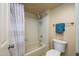 Bathroom featuring a shower with tile surround, toilet, and towel rack at 12222 N Paradise Village S Pkwy # 405, Phoenix, AZ 85032