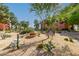 Scenic desert landscape featuring various cacti, gravel ground cover, and lush trees around the building at 12222 N Paradise Village S Pkwy # 405, Phoenix, AZ 85032